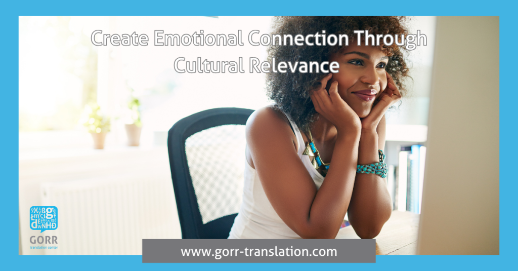 A woman with curly hair smiling at her computer, GORR creates emotional connection with clients.